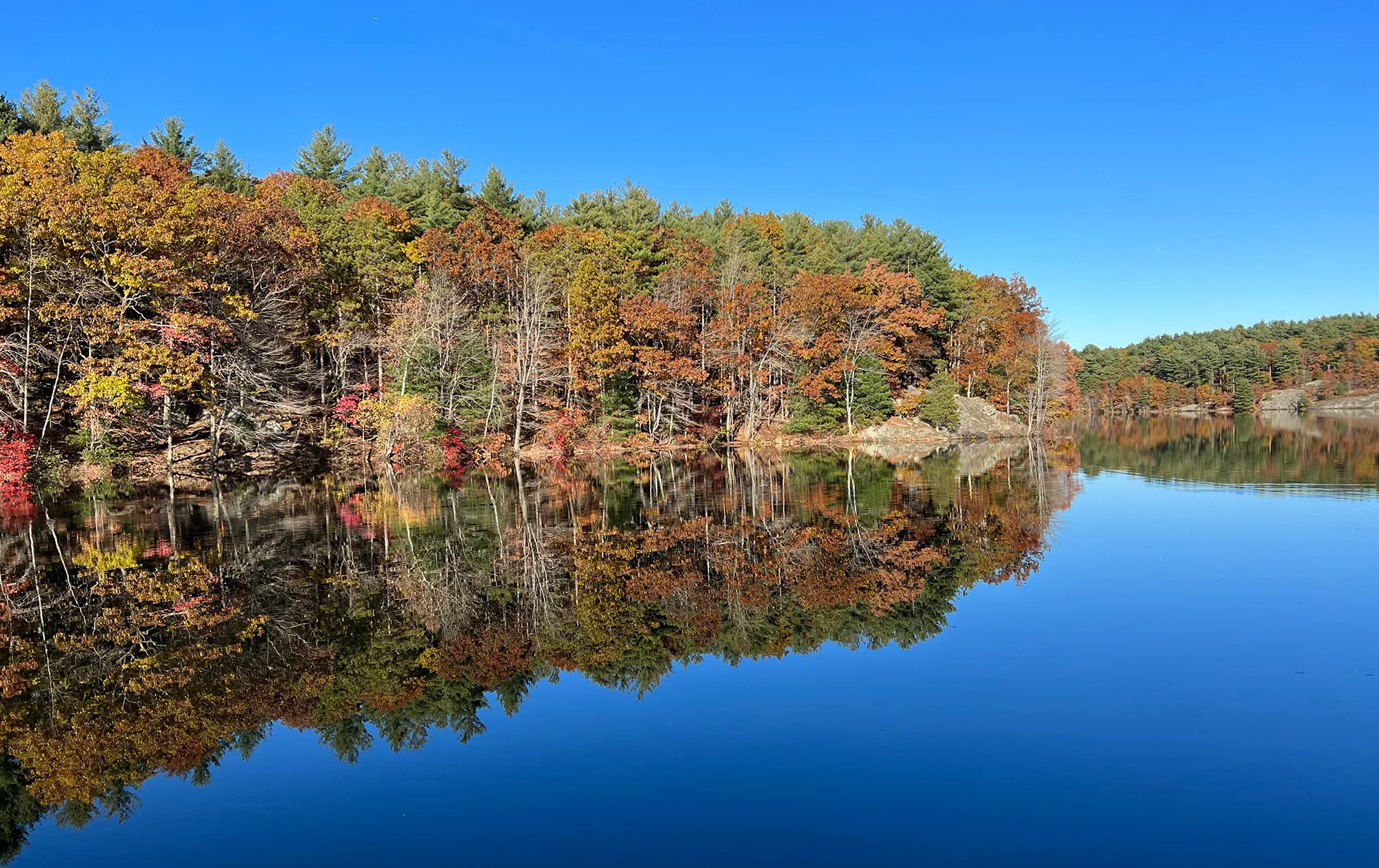Autumn foliage reflected in the Middle Reservoir at Middlesex Fells Reservation.